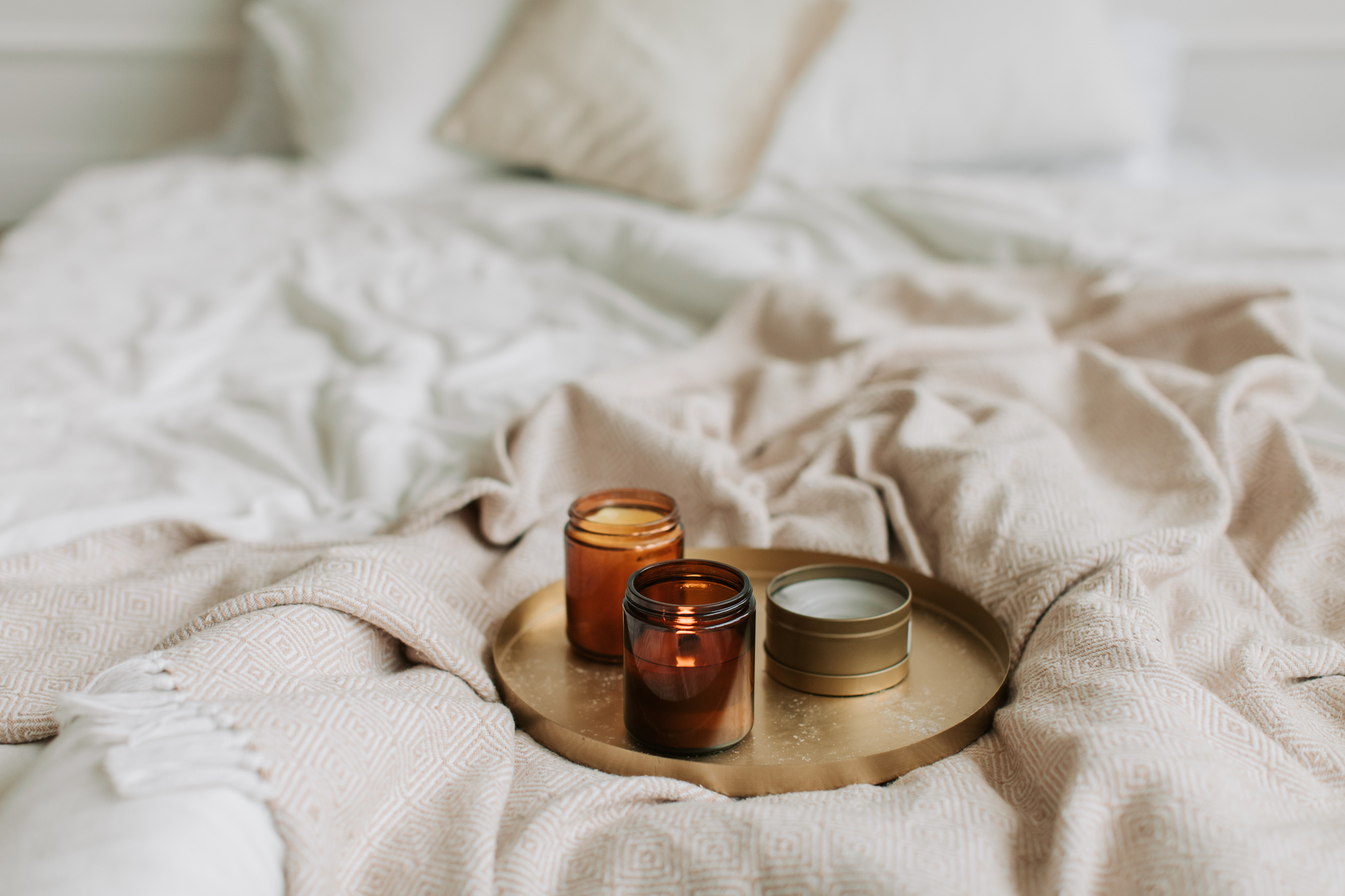 Lighted Candles on Bronze Tray on Bed